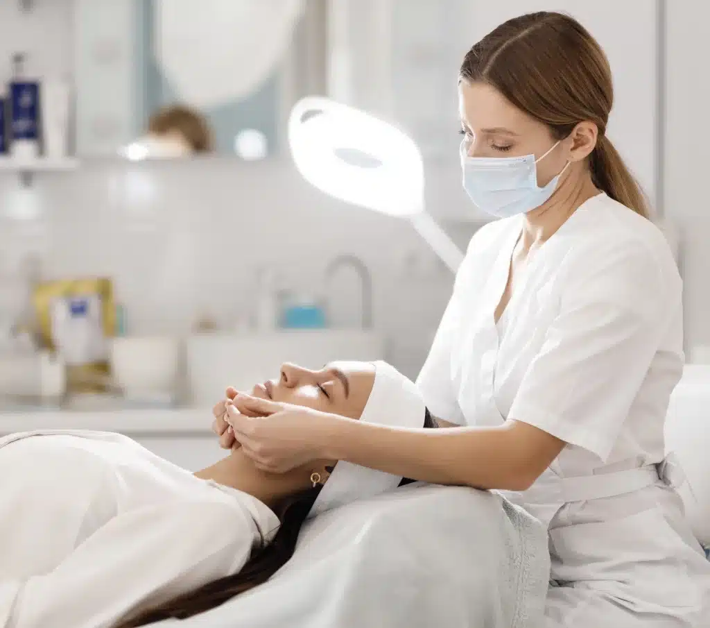 Professional performing under-chin fat removal procedure.